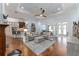 Bright living room with hardwood floors, tray ceiling, neutral furniture and an open layout to the kitchen and dining room at 1103 Se 46Th St, Ocala, FL 34480