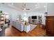 Bright living room with hardwood floors, tray ceiling, neutral furniture and an open layout to the kitchen and dining room at 1103 Se 46Th St, Ocala, FL 34480