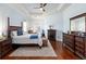 Spacious main bedroom features a tray ceiling, hardwood floors, and a walkout to the lanai at 1103 Se 46Th St, Ocala, FL 34480