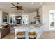 Covered outdoor kitchen with stone accents, granite counters, grill, sink, and seating offers luxury living at 1103 Se 46Th St, Ocala, FL 34480