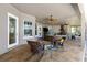 Covered outdoor living space with kitchen, lounge, fireplace, and rocking chairs at 1103 Se 46Th St, Ocala, FL 34480