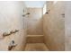 Walk-in shower features a bench, multiple shower heads, and beautiful tile work at 1103 Se 46Th St, Ocala, FL 34480