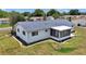 Bird's-eye view of a home with tidy landscaping, a screen enclosed patio, and a well-maintained yard at 11118 Sw 76Th Ave, Ocala, FL 34476