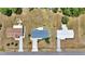Overhead view of three homes with driveways and landscaping, surrounded by mature trees in a suburban area at 11118 Sw 76Th Ave, Ocala, FL 34476