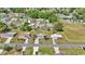 Aerial view of a peaceful neighborhood showcasing well-maintained homes, green lawns, and mature trees at 11118 Sw 76Th Ave, Ocala, FL 34476