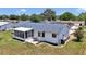 Well-kept backyard featuring a screened lanai, patio area, and neatly edged garden beds around the lawn at 11118 Sw 76Th Ave, Ocala, FL 34476