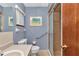 This accessible bathroom includes a tile shower and blue painted walls at 11118 Sw 76Th Ave, Ocala, FL 34476