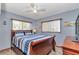 This bedroom has hardwood furniture and a blue bedspread at 11118 Sw 76Th Ave, Ocala, FL 34476