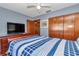Bedroom with television, hardwood furniture and natural light at 11118 Sw 76Th Ave, Ocala, FL 34476