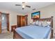 This bedroom features wood frame bed, plush pillows, and attached bathroom at 11118 Sw 76Th Ave, Ocala, FL 34476