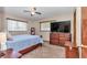 Comfortable bedroom with carpet, ceiling fan, and wooden furniture at 11118 Sw 76Th Ave, Ocala, FL 34476