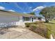 Attractive home featuring blue shutters, a manicured lawn, mature landscaping, and an attached two-car garage at 11118 Sw 76Th Ave, Ocala, FL 34476