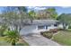 Charming home featuring blue shutters, a well-manicured lawn, mature landscaping, and an attached two-car garage at 11118 Sw 76Th Ave, Ocala, FL 34476