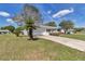 Attractive home featuring blue shutters, a manicured lawn, mature landscaping, and an attached two-car garage at 11118 Sw 76Th Ave, Ocala, FL 34476