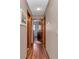 Hallway featuring wood floors and wood trim at 11118 Sw 76Th Ave, Ocala, FL 34476