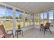 Bright sunroom with tile floors and windows showcasing the beautiful backyard view, ideal for relaxation at 11118 Sw 76Th Ave, Ocala, FL 34476