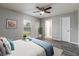 Serene bedroom with a ceiling fan, large window, and a peaceful ambiance perfect for relaxation at 11887 Se 71St Ave, Belleview, FL 34420
