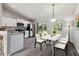 Well-lit dining area featuring modern decor, a view to the yard, and direct access to the kitchen at 11887 Se 71St Ave, Belleview, FL 34420