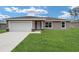 Charming single-story home with a well-manicured lawn and attached two-car garage at 11887 Se 71St Ave, Belleview, FL 34420