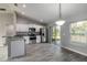 Open kitchen featuring stainless steel appliances and an adjacent dining area with sliding glass door to the yard at 11887 Se 71St Ave, Belleview, FL 34420
