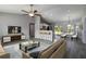 Open-concept living space with vaulted ceilings, fan, and seamless flow to the kitchen and dining area at 11887 Se 71St Ave, Belleview, FL 34420