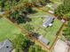 Expansive property with fenced yard, lush lawn, mature trees, and a long driveway leading to the house at 13897 W Highway 328, Ocala, FL 34482