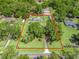 Aerial view of a sprawling property surrounded by lush greenery and mature trees providing privacy at 13897 W Highway 328, Ocala, FL 34482