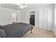Bright bedroom featuring wood look floors, ceiling fan and spacious closet space at 13897 W Highway 328, Ocala, FL 34482