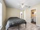 Bedroom featuring a ceiling fan, wood look floors with ensuite bathroom at 13897 W Highway 328, Ocala, FL 34482