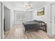Well lit bedroom with ceiling fan, wood look floors, closet and large windows at 13897 W Highway 328, Ocala, FL 34482