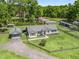 Aerial view of a charming home with a well-manicured lawn and mature trees surrounding the property at 13897 W Highway 328, Ocala, FL 34482