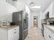 Bright kitchen featuring stainless steel appliances, white cabinets and wood look floors at 13897 W Highway 328, Ocala, FL 34482