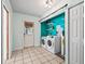 Laundry room featuring washer, dryer, utility sink and shelving with direct access to exterior at 13897 W Highway 328, Ocala, FL 34482