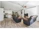 Bright and open living room featuring vaulted ceilings, tile floors, and modern furnishings at 13897 W Highway 328, Ocala, FL 34482