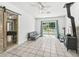 Open living room with access to the backyard and a bedroom with hardwood barn door at 13897 W Highway 328, Ocala, FL 34482