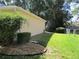The side yard features grass and landscaped garden at 14244 Sw 115Th Cir, Dunnellon, FL 34432