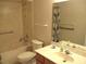 Bathroom featuring a bathtub with shower, toilet, sink, and mirrored cabinet at 14244 Sw 115Th Cir, Dunnellon, FL 34432