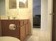 Bathroom featuring a toilet, vanity with mirror, and doorway to another room at 14244 Sw 115Th Cir, Dunnellon, FL 34432