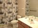 Bathroom featuring a toilet, shower with curtain, sink, and mirrored cabinet at 14244 Sw 115Th Cir, Dunnellon, FL 34432