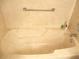 Classic bathtub with a marble-like finish and convenient grab bar for added safety at 14244 Sw 115Th Cir, Dunnellon, FL 34432