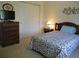 Cozy bedroom with a closet, dresser, and bedside table, providing ample storage and comfort at 14244 Sw 115Th Cir, Dunnellon, FL 34432