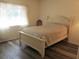 Bright bedroom featuring a comfortable bed and a large window with sheer curtains at 14244 Sw 115Th Cir, Dunnellon, FL 34432