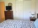 Cozy bedroom featuring a warm-toned dresser and a matching decorative lamp at 14244 Sw 115Th Cir, Dunnellon, FL 34432