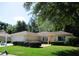 Charming single-story home with a manicured lawn and mature trees providing ample shade at 14244 Sw 115Th Cir, Dunnellon, FL 34432