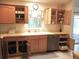 Traditional eat-in kitchen features tile backsplash and stainless steel dishwasher at 14244 Sw 115Th Cir, Dunnellon, FL 34432