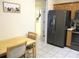 View of kitchen with stainless steel refrigerator and breakfast nook with seating at 14244 Sw 115Th Cir, Dunnellon, FL 34432