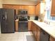 Well-equipped kitchen featuring stainless steel appliances, ample cabinetry, and tile flooring at 14244 Sw 115Th Cir, Dunnellon, FL 34432