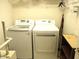 The laundry room includes a full-size washer and dryer and wire rack shelving at 14244 Sw 115Th Cir, Dunnellon, FL 34432