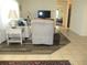 Cozy living room with wood-look and tile flooring, comfortable furniture, and open access to other rooms at 14244 Sw 115Th Cir, Dunnellon, FL 34432