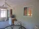 The sunroom has sliding glass doors leading inside the home, a mini fridge, and a ceiling fan at 14244 Sw 115Th Cir, Dunnellon, FL 34432